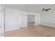 Bright living room with wood floors, statement wallpaper, and double doors leading to another room at 1021 E Myrtle Ave, Phoenix, AZ 85020