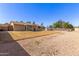 Expansive backyard featuring gravel landscaping, a covered patio, and a private, fenced yard at 1022 W Watson Dr, Tempe, AZ 85283