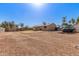 Spacious backyard with gravel landscaping, partially xeriscaped with a covered patio, perfect for outdoor activities at 1022 W Watson Dr, Tempe, AZ 85283