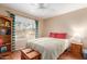 Cozy bedroom with natural light, showcasing a bed, a ceiling fan, and a view of the outdoors at 1022 W Watson Dr, Tempe, AZ 85283