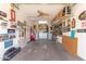 Garage featuring car-themed decor, a ceiling fan, built-in shelving, and a laundry area for convenience at 1022 W Watson Dr, Tempe, AZ 85283