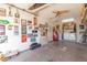 Garage featuring car-themed decor, a ceiling fan, built-in shelving, and a laundry area for convenience at 1022 W Watson Dr, Tempe, AZ 85283