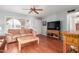 Comfortable living room with wood flooring, a ceiling fan, and lots of natural light at 1022 W Watson Dr, Tempe, AZ 85283