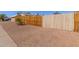 Gated side yard with gravel landscaping and secure wooden fencing for enhanced privacy at 1022 W Watson Dr, Tempe, AZ 85283