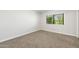 Bright bedroom featuring carpet and a window with blinds at 10404 W Tropicana S Cir, Sun City, AZ 85351