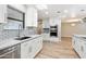 Updated kitchen with stainless steel appliances, white cabinetry, and subway tile backsplash at 10404 W Tropicana S Cir, Sun City, AZ 85351