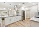 Bright modern kitchen with stainless steel appliances and fixtures, bar seating and hardwood floors at 10404 W Tropicana S Cir, Sun City, AZ 85351