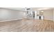 Open living space with hardwood floors that flows to kitchen and bar area at 10404 W Tropicana S Cir, Sun City, AZ 85351