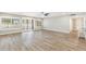 Spacious living room featuring hardwood flooring, modern ceiling fan, and lots of natural light at 10404 W Tropicana S Cir, Sun City, AZ 85351