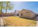 Wide angle of a fully fenced backyard with gravel and grass at 1110 W Seagull Dr, Chandler, AZ 85286