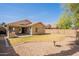 A fully fenced backyard with gravel and grass and a covered patio at 1110 W Seagull Dr, Chandler, AZ 85286
