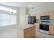 Functional kitchen with an island, black appliances, and a bright window at 1110 W Seagull Dr, Chandler, AZ 85286