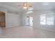 Bright living room with tile flooring, ceiling fan, and sliding door access to the backyard at 1110 W Seagull Dr, Chandler, AZ 85286