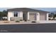 Charming single-story home featuring a two-car garage, neutral color palette, and low maintenance front yard at 11818 N Vanero Ct, Maricopa, AZ 85139