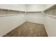 Empty walk-in closet ready for customization with ample space and neutral carpeting at 11818 N Vanero Ct, Maricopa, AZ 85139