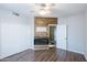 Bedroom with light walls, wood-look floors, fireplace, and wood accent wall at 1249 W Seascape Dr, Gilbert, AZ 85233