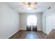 This bright bedroom features wood floors, a ceiling fan, and sheer curtains at 1249 W Seascape Dr, Gilbert, AZ 85233