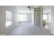Large bedroom with neutral carpet, ceiling fan, and bright natural light at 1249 W Seascape Dr, Gilbert, AZ 85233