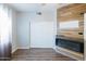 A modern bedroom featuring a wooden accent wall and fireplace with wood-look floors at 1249 W Seascape Dr, Gilbert, AZ 85233