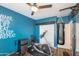 A home gym featuring a stationary bike, punching bag, and inspirational wall art at 1249 W Seascape Dr, Gilbert, AZ 85233