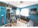 Home exercise room features a treadmill, stationary bike, punching bag, and mounted TV at 1249 W Seascape Dr, Gilbert, AZ 85233