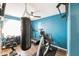 A home gym includes a punching bag, stationary bike, and a motivational wall decal at 1249 W Seascape Dr, Gilbert, AZ 85233