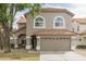 Charming two-story home featuring a well-manicured lawn, neutral colored exterior, and a two car garage at 1249 W Seascape Dr, Gilbert, AZ 85233