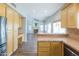 Open-concept kitchen flows into living space with fireplace and abundant natural light at 1249 W Seascape Dr, Gilbert, AZ 85233