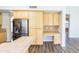 Kitchen with wood cabinets and a refrigerator/freezer, attached desk, and tile floors at 1249 W Seascape Dr, Gilbert, AZ 85233