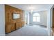 Cozy living room with an ornate mirror, wood wall, and a view of another room with a chandelier at 1249 W Seascape Dr, Gilbert, AZ 85233
