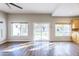 Bright and airy living room featuring vinyl floors and backyard views from sliding glass door at 1249 W Seascape Dr, Gilbert, AZ 85233