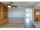 Living room featuring hardwood and carpet flooring with a built in bookshelf at 1249 W Seascape Dr, Gilbert, AZ 85233