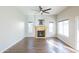 Bright living room with ceiling fan, fireplace, and vinyl flooring at 1249 W Seascape Dr, Gilbert, AZ 85233