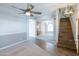 An open concept living room featuring hardwood and carpet flooring and stairs leading to the second floor at 1249 W Seascape Dr, Gilbert, AZ 85233