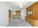 Spacious living room showcasing a decorative light fixture, ornate mirror, and access to other living areas at 1249 W Seascape Dr, Gilbert, AZ 85233