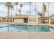 Community pool featuring clear water and nearby clubhouse surrounded by tall, swaying palm trees at 1249 W Seascape Dr, Gilbert, AZ 85233