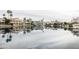 Waterfront view featuring luxury homes along calm water with private boat docks under a cloudy sky at 1249 W Seascape Dr, Gilbert, AZ 85233