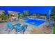 Stunning backyard pool with a baja shelf, adjacent spa, and landscaped outdoor living area at 12859 W Calle De Baca --, Peoria, AZ 85383