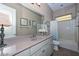 Functional bathroom featuring a large vanity with countertop space, tub-shower combo, and neutral tile at 12859 W Calle De Baca --, Peoria, AZ 85383
