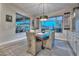 Stylish dining room featuring a modern chandelier, a wooden table, and natural light from the windows at 12859 W Calle De Baca --, Peoria, AZ 85383