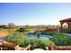 Outdoor living space with a beautiful fountain, desert views, and comfortable seating at 12859 W Calle De Baca --, Peoria, AZ 85383