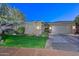 Charming single-story home with a well-manicured lawn, stone accents, and an attached two-car garage at 12859 W Calle De Baca --, Peoria, AZ 85383