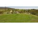 Scenic view of a golf course, with desert vegetation, distant mountains, and a serene pond at 12859 W Calle De Baca --, Peoria, AZ 85383