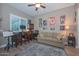 Comfortable office space with desk, chair, and sofa; decorated with vintage posters and artwork at 12859 W Calle De Baca --, Peoria, AZ 85383