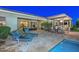 Gorgeous pool and patio area featuring lounge chairs, a bar with seating, and a covered outdoor kitchen at 12859 W Calle De Baca --, Peoria, AZ 85383