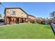 Wide backyard view with covered patio and lush lawn, ideal for relaxing or entertaining outdoors at 1322 S 118Th Dr, Avondale, AZ 85323