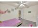 Light-filled bedroom with gray carpet, pink bedding, and decorated walls at 1322 S 118Th Dr, Avondale, AZ 85323