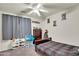 Cozy bedroom with gray carpet, a ceiling fan, and decor at 1322 S 118Th Dr, Avondale, AZ 85323