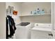 Functional laundry room with modern washer and dryer, offering ample storage and convenience at 1322 S 118Th Dr, Avondale, AZ 85323