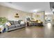 A living room area featuring wood look tile flooring, contemporary lighting, and modern furniture at 1322 S 118Th Dr, Avondale, AZ 85323